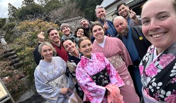 Group wearing traditional attire, posing outdoors.