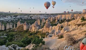Iconic fairy chimneys with hot air balloons in the sky.