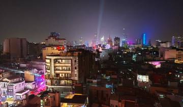 Cityscape at night with bright lights and buildings.
