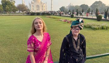 Two people dressed in traditional attire at the Taj Mahal.