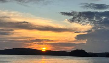 Beautiful sunset with the sun setting over the horizon and dramatic clouds.