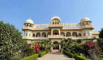 A grand palace with lush gardens and flowers.