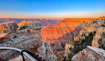 Grand Canyon view with rock formations and sunset lighting.
