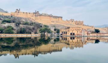 A large fort reflected in a lake.