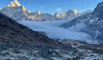 A panoramic view of mountains and a cloud-filled valley.