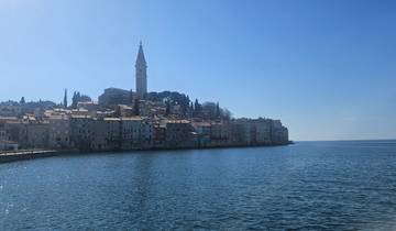A coastal town with medieval architecture against a clear sky.