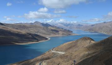 A stunning view of a large lake with mountains in the background.