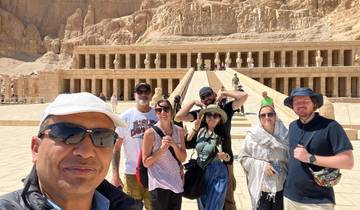 Tourists posing in front of a historic temple structure.