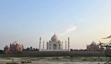 Wide view of the Taj Mahal from the riverside with clear sky.