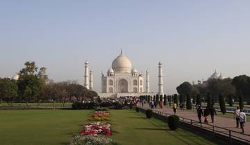 Iconic view of the Taj Mahal with gardens and visitors.