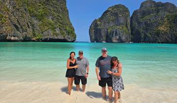 Group of people standing on a tropical beach.