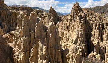 Eroded rock formations in a valley landscape.