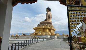 Large Buddha statue overlooking the landscape.