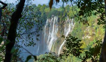 Elegant cascading waterfalls surrounded by trees.