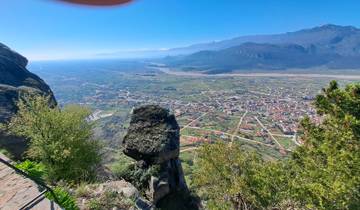 A scenic view from a high vantage point overlooking a town and valley.
