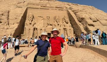 A group of tourists posing in front of The Temple of Abu Simbel.