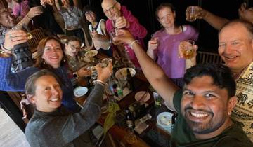Group of people raising glasses in celebration.