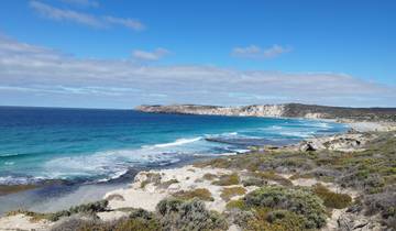 Scenic coastal view with white sand beaches and clear blue water.