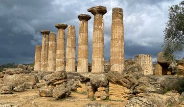Ancient columns standing against a dramatic sky.