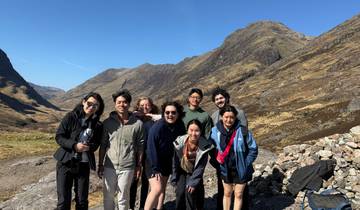Group posing in front of a mountainous landscape.