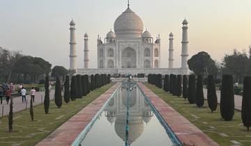 The Taj Mahal with a reflection pool and visitors.