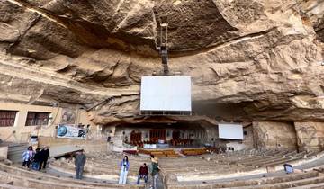 Large auditorium set inside an impressive rock formation.