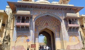 Intricately designed gate of a fort with a blue ornamented archway.