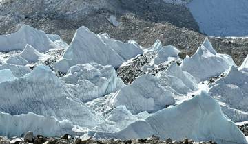 Ice formations and snowy mountains in a high-altitude region.