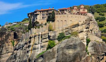 Monastery built on top of a steep rock formation.