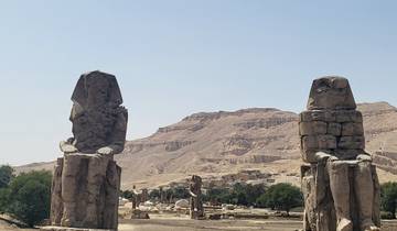 Colossi of Memnon statues with landscape in background.