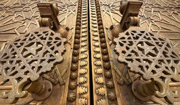 Intricate design on a large metallic door.