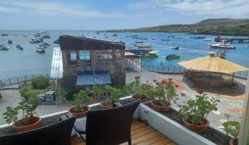 Scenic view of a harbor with boats and a gazebo.