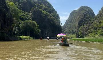 Rowing boats on a scenic river through limestone karsts.