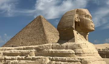 Sphinx and pyramid under a clear sky.
