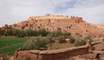 Historic earth-toned village set against a desert landscape.