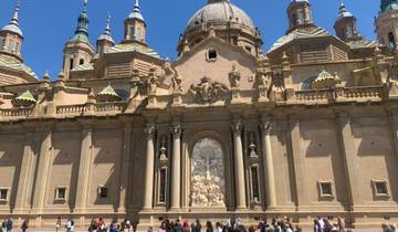 An ornate historic building with domes and sculptures.