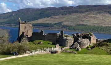 Ruins of a historical castle next to a lake.