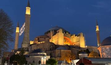 Imposing domed building illuminated at night.