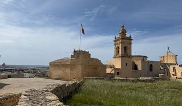 Historic building with a flag on a clear day