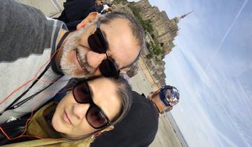 Two people in front of Mont Saint-Michel.