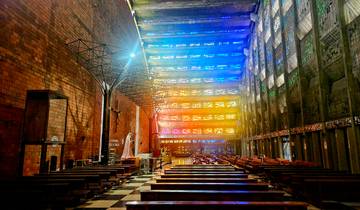 Colorful stained glass windows inside a brick church.