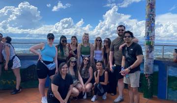 Group of people posing with a scenic view in the background.