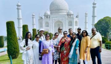 Group of people posing in front of the iconic Taj Mahal.