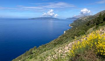 Expansive view of the coastline with blue sea and distant islands.