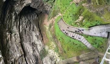 Overhead view of a large cave entrance with walkway.