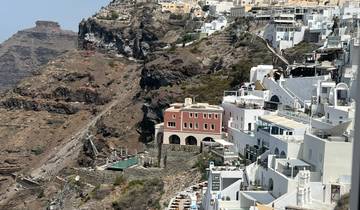Cliffside view of buildings with white facades.