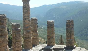 Ancient ruins with mountainous landscape in the background.