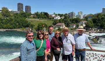 A group enjoying a riverside view in Switzerland.