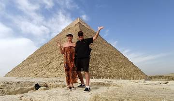 Two people posing in front of the Pyramid of Giza.