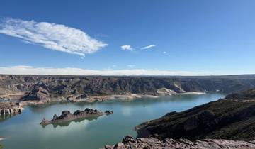 Scenic view of a tranquil lake and the surrounding mountains.